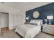 Charming bedroom with a striking accent wall, inviting white bed, and elegant side tables at 5107 Maddox Ln, Whitestown, IN 46075