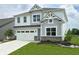 Charming two-story home with a manicured lawn, attached two-car garage and beautiful gray and white color scheme at 5107 Maddox Ln, Whitestown, IN 46075