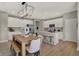 Modern open layout with a kitchen island, stainless steel appliances, white cabinetry, and hardwood floors at 5107 Maddox Ln, Whitestown, IN 46075