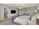 This main bedroom features a gorgeous chandelier, TV, and a beautifully decorated ensuite bathroom at 5107 Maddox Ln, Whitestown, IN 46075