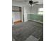 Neutral bedroom with carpet, closet, ceiling fan, and green accent paint at 515 Wedgewood Dr, Anderson, IN 46013