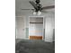Spacious bedroom with plush gray carpet, walk-in closet and ceiling fan at 515 Wedgewood Dr, Anderson, IN 46013