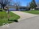Charming single-story home with a concrete driveway and freshly cut lawn at 515 Wedgewood Dr, Anderson, IN 46013