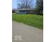 A well-maintained lawn surrounds a charming single-story home with a sunroom at 515 Wedgewood Dr, Anderson, IN 46013