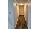 Long hallway with modern hardwood flooring and access to multiple rooms at 515 Wedgewood Dr, Anderson, IN 46013