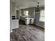 Kitchen features an eat-in counter, updated cabinets, and hardwood flooring at 515 Wedgewood Dr, Anderson, IN 46013