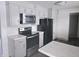 Modern kitchen with stainless steel appliances and white cabinets at 515 Wedgewood Dr, Anderson, IN 46013