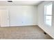 Bright bedroom featuring new carpet and a window at 521 N Swain St, Ingalls, IN 46048