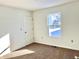 Well-lit bedroom with new carpet and closet at 521 N Swain St, Ingalls, IN 46048