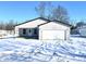 Newly built home with grey siding, white garage door, and a wintery landscape at 521 N Swain St, Ingalls, IN 46048