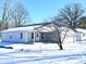 Newly built home with grey siding, covered porch, and a snowy yard at 521 N Swain St, Ingalls, IN 46048