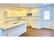 Modern kitchen featuring white cabinets, granite countertops, and a kitchen island at 521 N Swain St, Ingalls, IN 46048