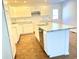 Modern kitchen with white cabinets, granite countertops and island at 521 N Swain St, Ingalls, IN 46048