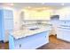 Modern kitchen with white cabinets, granite countertops, and a large island at 521 N Swain St, Ingalls, IN 46048