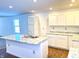 Modern kitchen with white cabinets, granite countertops, and an island at 521 N Swain St, Ingalls, IN 46048