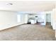 Open concept kitchen and living room with new carpet and appliances at 521 N Swain St, Ingalls, IN 46048