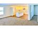 Open living room with carpet, an open concept kitchen, and access to other rooms at 521 N Swain St, Ingalls, IN 46048