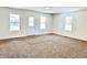 Spacious living room with new carpet and large windows at 521 N Swain St, Ingalls, IN 46048