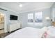 Main bedroom with white dresser, king bed, and ensuite bathroom access at 559 Fulton St, Indianapolis, IN 46202