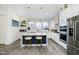 Modern white kitchen with marble island and stainless steel appliances at 559 Fulton St, Indianapolis, IN 46202
