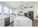 Modern kitchen boasts white cabinets, a large island, and stainless steel appliances at 559 Fulton St, Indianapolis, IN 46202