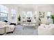 Bright and airy living room with large windows and comfy seating at 559 Fulton St, Indianapolis, IN 46202