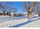 Back of house and yard with snow cover at 5965 Bluff Rd, Indianapolis, IN 46217