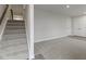 Unfinished basement with carpeted floor and stairs leading upstairs at 6322 Loraine Dr, Brownsburg, IN 46112