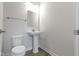Modern bathroom with pedestal sink, toilet and mirror at 6322 Loraine Dr, Brownsburg, IN 46112