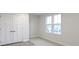 Simple bedroom with neutral walls, carpeted floor, and double doors at 6322 Loraine Dr, Brownsburg, IN 46112