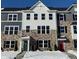Two-story townhome with stone and gray siding, and a red front door at 6322 Loraine Dr, Brownsburg, IN 46112