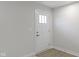 Simple white front door with glass panels in a light-colored room at 6322 Loraine Dr, Brownsburg, IN 46112