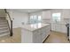 Modern kitchen with white cabinets and center island at 6322 Loraine Dr, Brownsburg, IN 46112