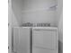 Bright laundry room, featuring washer and dryer and overhead shelving at 6322 Loraine Dr, Brownsburg, IN 46112