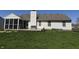 Backyard view features a wooden deck with seating, green grass, and partial view of white siding house at 6615 Rushing, Noblesville, IN 46062