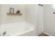Cozy bathroom featuring a soaking tub and a shower with white curtain at 6615 Rushing, Noblesville, IN 46062