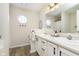 Bright bathroom with double sinks, white cabinets, modern fixtures, and an octagon window at 6615 Rushing, Noblesville, IN 46062