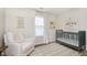 Adorable Bedroom with a crib, soft chair, and natural light from the window at 6615 Rushing, Noblesville, IN 46062