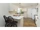 Well-lit kitchen featuring white cabinets and a breakfast bar at 6615 Rushing, Noblesville, IN 46062
