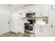 Efficient kitchen with stainless steel range, microwave, and ample storage at 6615 Rushing, Noblesville, IN 46062