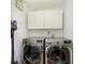 Convenient laundry room with modern washer and dryer and overhead storage cabinets at 6615 Rushing, Noblesville, IN 46062