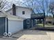View of the backyard with a detached garage and upper-level deck. Ideal for outdoor relaxation and entertainment at 810 Kendale Ct, Indianapolis, IN 46234