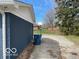 View of the backyard, highlighting the driveway and lawn. Plenty of space and privacy for outdoor enjoyment at 810 Kendale Ct, Indianapolis, IN 46234