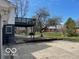 Spacious backyard featuring a concrete patio, lush greenery, and an upper level deck for relaxing and entertaining at 810 Kendale Ct, Indianapolis, IN 46234