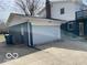 Backyard showcasing the detached garage with ample parking and storage, and an upper-level deck at 810 Kendale Ct, Indianapolis, IN 46234