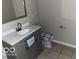 Updated bathroom with gray vanity and tile flooring at 810 Kendale Ct, Indianapolis, IN 46234
