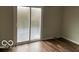 Bedroom with sliding glass door and wood-look flooring at 810 Kendale Ct, Indianapolis, IN 46234