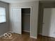 Bedroom with good closet space and neutral walls at 810 Kendale Ct, Indianapolis, IN 46234