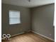 Spacious bedroom with hardwood floors and neutral walls at 810 Kendale Ct, Indianapolis, IN 46234
