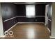 Bright dining room features hardwood floors and dark-painted walls at 810 Kendale Ct, Indianapolis, IN 46234